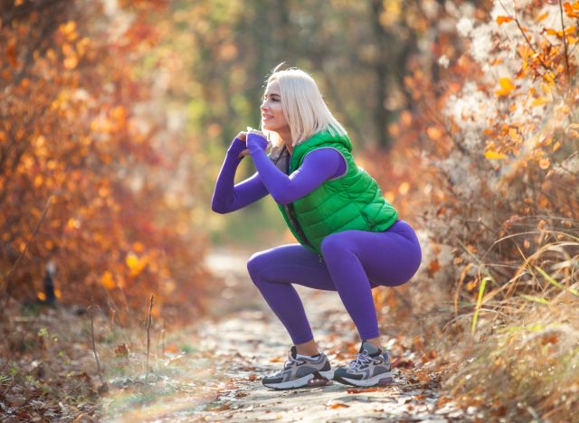 Fitness nő, aki guggolást végez a szabadban, és gyakorlatokat mutat be a test alakjának megváltoztatására 40 év után